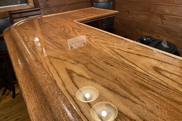 A wooden epoxy bar top with a pristine finish.